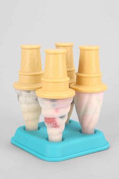 four ice cream cones are stacked on top of each other in different shapes and sizes