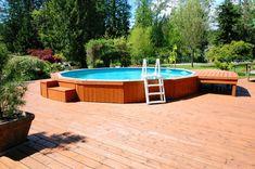 an above ground pool with steps leading up to it and a ladder leaning against the wall