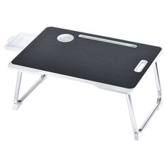 a black and white desk with a laptop on it's side table, which is attached to a metal frame