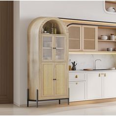 a kitchen with white cabinets and wooden shelves in the center, along with an arched doorway that leads to another room