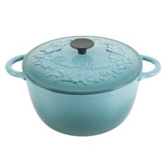 a blue casserole with an ornate design on the lid