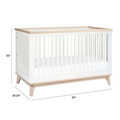 a white crib with the measurements for it