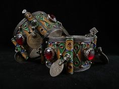 A high graded silver set of old Berber hinged enameled bracelets of Tiznit, Morocco, 1950s. I bought them in 2006 in Tiznit. Overall in good condition. The bracelets have each 4 red glass cabochons and 4 old French coins (50 centimes).On both bracelets there are engravings, see picture 3 Total weight is 225,6 grams ( 113,1 + 112,5). The width of a bracelets is 3.6 cm The inner Ø IS 5.8 CM Moroccan Bracelet, French Coins, Silver Enamel, Red Glass, The Netherlands, Morocco, Netherlands, Glass, Silver