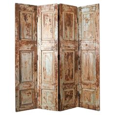 an old wooden room divider with peeling paint