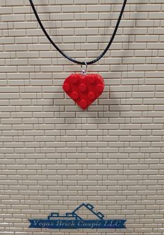 Custom handmade Heart Necklace made with genuine Lego® pieces. The necklace is made from waxed cotton cord and is 20” long and 1.5mm thick with a 2" extender chain and lobster clasp. These are made with all new parts including two standard Lego® heart shaped plates that have been glued together to provide long term durability. Vegas Brick Couple LLC is not affiliated with LEGO®. This product is fan art and the LEGO logo, are registered trademarks of The LEGO Group, which does not authorize, spon Red Adjustable Heart-shaped Necklace, Red Adjustable Heart Necklace, Adjustable Red Heart Necklace, Adjustable Red Necklaces With Heart Charm, Red Heart-shaped Adjustable Necklace, Handmade Adjustable Heart Necklace For Valentine's Day, Heart Shaped Necklace With Adjustable Cord As Gift, Red Adjustable Heart Pendant Necklace, Adjustable Red Heart Necklace Gift