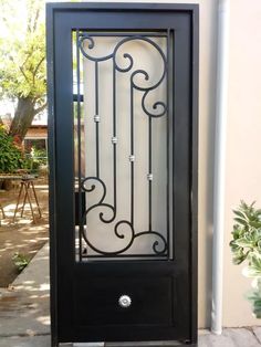 a black door with an iron design on it