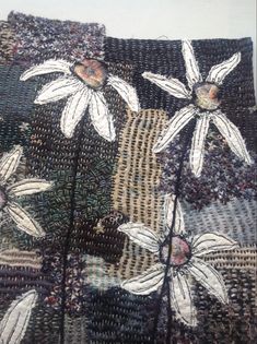 a close up of a piece of cloth with white flowers on the inside of it