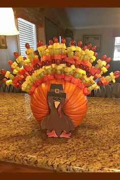 a turkey made out of candy sitting on top of a counter next to a lamp