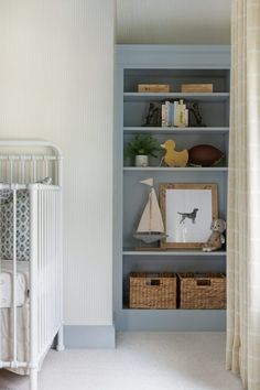 a baby's room with a crib and bookshelf