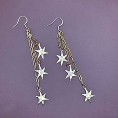 These gold earrings have varying lengths of chain with small irregular stars dangling from each strand. The textured stars are very lightweight and made of brass. Approx. 4"Hammered star charms are lightweight brass. The chain and ear hooks are made of stainless steel. -------------- 🔨 I stamp each letter/design by hand with traditional tools so each item is truly one of a kind. This also means your piece won’t look exactly as pictured. Due to the nature of stamping there may be a slight impres Brass Dangle Jewelry With Star Charm, Star-shaped Metal Jewelry With Dangling Charms, Star-shaped Metal Earrings With Dangling Charms, Star Earrings Dangle, Stamp Letter, Semi Permanente, Earring Pins, Heart Dangle Earrings, Letter Design