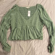 Sage / Light Green A Bay Doll Style Top Cute Long Sleeve Tops For Spring, Cute Long Sleeve Spring Tops, Cute V-neck Top For Fall, Cute Long Sleeve Summer Tops, Cute Fitted Long Sleeve Tops, Casual Long Sleeve Top With Ruffles For Spring, Cute Fitted Green Blouse, Cute Long Sleeve Tops With Ruffles, Cute Green Spring Blouse