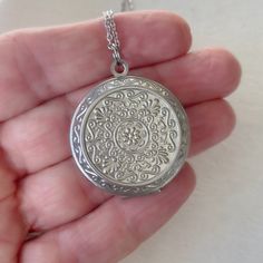 "This is a smaller version of a popular extra large locket in my shop. Timeless and classic, this beautiful embossed silver locket will become a special addition to your jewelry collection. The locket is 27mm in diameter (a little larger than a quarter), smooth silver plated brass, and opens for a secret place to keep pictures, messages, or whatever you like. The locket has a stainless steel chain with a lobster clasp. You may choose 18\", 20\" or 24\" length. This locket can hold two 22mm inser Adjustable Round Pendant Locket Necklace, Round Locket Jewelry For Personalized Gift, Adjustable Round Locket Pendant Necklace, Personalized Round Locket Jewelry Gift, Personalized Round Sterling Silver Locket Necklace, Personalized Round Locket Jewelry, Personalized Spiritual Medallion Locket Necklace, Silver Coin Pendant Locket Necklace As Gift, Silver Round Pendant Locket Necklace Gift