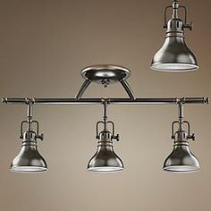 an overhead track light with five lights on each side and three hanging lamps above it