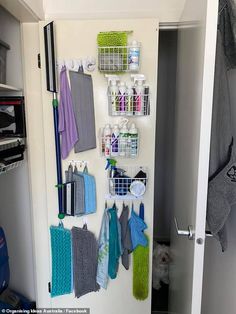 there is a closet with several items on the wall and hanging from it's hooks