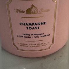 a bottle of champagne toast sitting on top of a counter next to a white wall