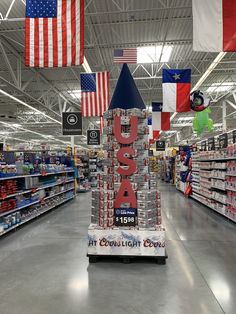 a display in a grocery store with flags hanging from it's ceiling and an upside down tower