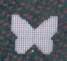 an image of a white bow on a red and black cloth with flowers in the background