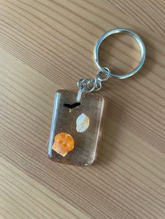 a glass keychain with an image of planets in it