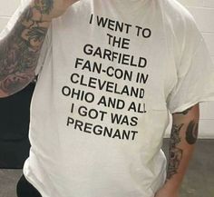 a man wearing a white t - shirt that says i went to the garfield fan - con in cleveland, ohio and all i got was pregnant