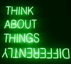 a green neon sign that says think about things at the bottom and below it are words