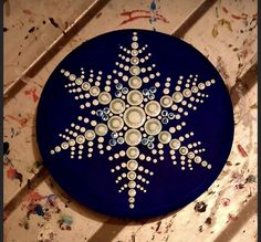 a blue plate with white dots and a snowflake design on the bottom, sitting on a table