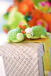 two green toy turtles sitting on top of a table