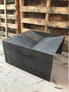 a large metal box sitting on top of a wooden pallet