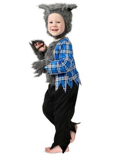 a little boy in a costume that is wearing a wolf hat and holding a cat