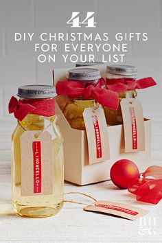 three jars filled with food sitting on top of a table next to ribbons and ribbon