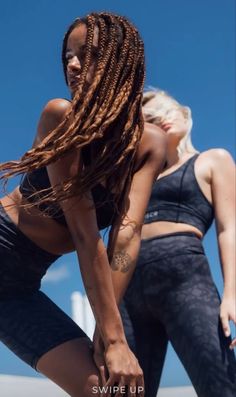 two women in black sports bra tops and leggings