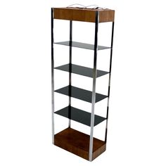 a tall metal and wood shelf with three shelves on one side, two glass shelves on the other