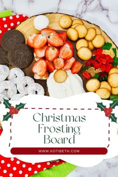 a christmas frosting board with cookies, strawberries and other holiday treats on it