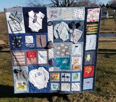 a quilt made to look like a baby's clothes on display in the grass