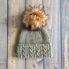 a knitted hat with a fur pom on the top, and text stating knitting pattern