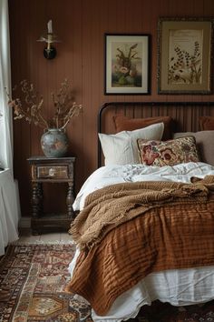 a bed sitting in a bedroom next to a window with pictures on the wall above it