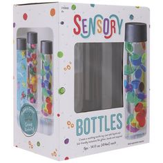 two bottles in a box with confetti on the bottom and one filled with gummy bears