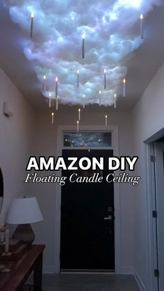 the ceiling is decorated with candles and clouds that are floating in the air above it