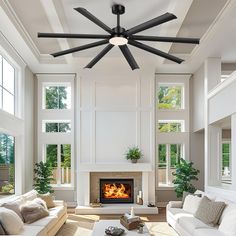 a living room filled with furniture and a fire place in the middle of two windows