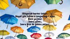 there are many colorful umbrellas hanging in the air together with words above them that read, bilogum here tetti hag