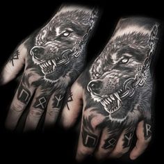 two hand tattoos with wolfs on them and chains hanging from the wrist, one is black