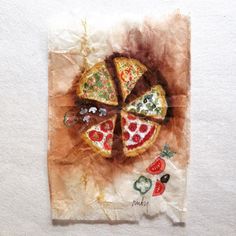 a piece of paper that has some pizza on it with toppings in the middle