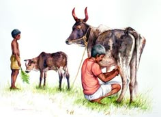 a man kneeling down next to a cow on top of a grass covered field with two other men standing behind him