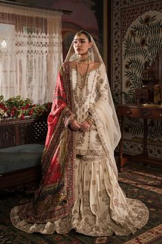 Gold Embroidered Pakistani Bridal Dress Classic Kameez Gharara is simply elegant, covered in motifs inspired by old Mughal imagery with delicate floral motifs and rich borders decorating the entire ghera. Bridal Gharara Designs, Gold Pakistani Bridal Dress, Gold Gharara, White Nikkah Dress, Red Gharara, Bridal Gharara, Nameera By Farooq, Bride Era, Bridal Sharara