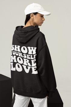 Show Yourself More Love Hoodie, Aesthetic Clothing, Positive Vibes Hoodie, Preppy Clothing, Y2K Hoodie, Unisex Hoodie A unisex heavy blend Show Yourself More Love hooded sweatshirt is relaxation itself. The material is a thick blend of cotton and polyester. This makes for a plush, soft feel alongside warmth. There are no side seams. A spacious kangaroo pocket hangs in front. The hood's drawstring is the same color as the base sweater. .: Model wearing an XL .: Runs true to size .: Size up for an Hooded Hoodie With Screen Print For Fall, Fall Slogan Hoodie For Streetwear, Screen Print Hooded Hoodie For Fall, Oversized Hoodie With Screen Print For Winter, Long Sleeve Hoodie With Text Print For Loungewear, Fall Slogan Hoodie For Loungewear, Hip Hop Hoodie With Screen Print For Fall, Trendy Black Hoodie With Screen Print, Trendy Long Sleeve Hoodie With Screen Print