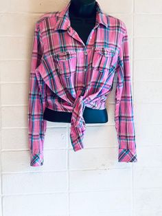 PINK PLAID OXFORD Lively pink button down shirt with blue stripes.  Long skinny sleeves with double button cuffs  Quality cotton  2 Button pockets Collar Made by Aeropostale  Marked Xl /16 fits smaller  View measurements below  Excellent condition Length 25" Shoulder back 17" Sleeve inseam 19" Chest 38 Retro Pink Button-up Top, Pink Buffalo Plaid, Pink Button-up Top With Button Cuffs, Casual Pink Button-up Flannel Shirt, Plaid Button-up Top With Pockets, Pink Button-up Tops With Button Closure, Pink Plaid, Aeropostale, Buffalo Plaid