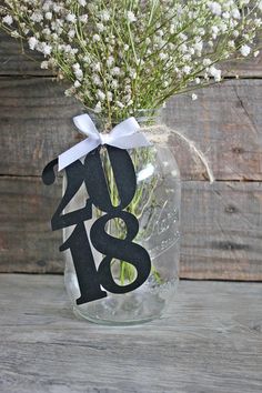 a vase filled with flowers on top of a wooden table