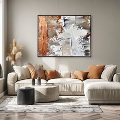 a living room filled with furniture and a large painting hanging on the wall above it