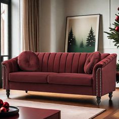 a living room with a red couch and christmas decorations on the table in front of it