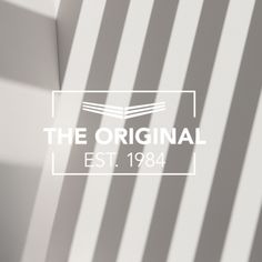 the logo for the original est 1994 is shown in white and gray stripes on a wall