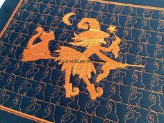 a blue and orange rug with an image of a lion on it's side